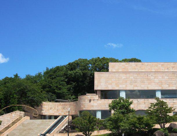 The Seimei Kaikan building, clad in Indian sandstone, set among gardens